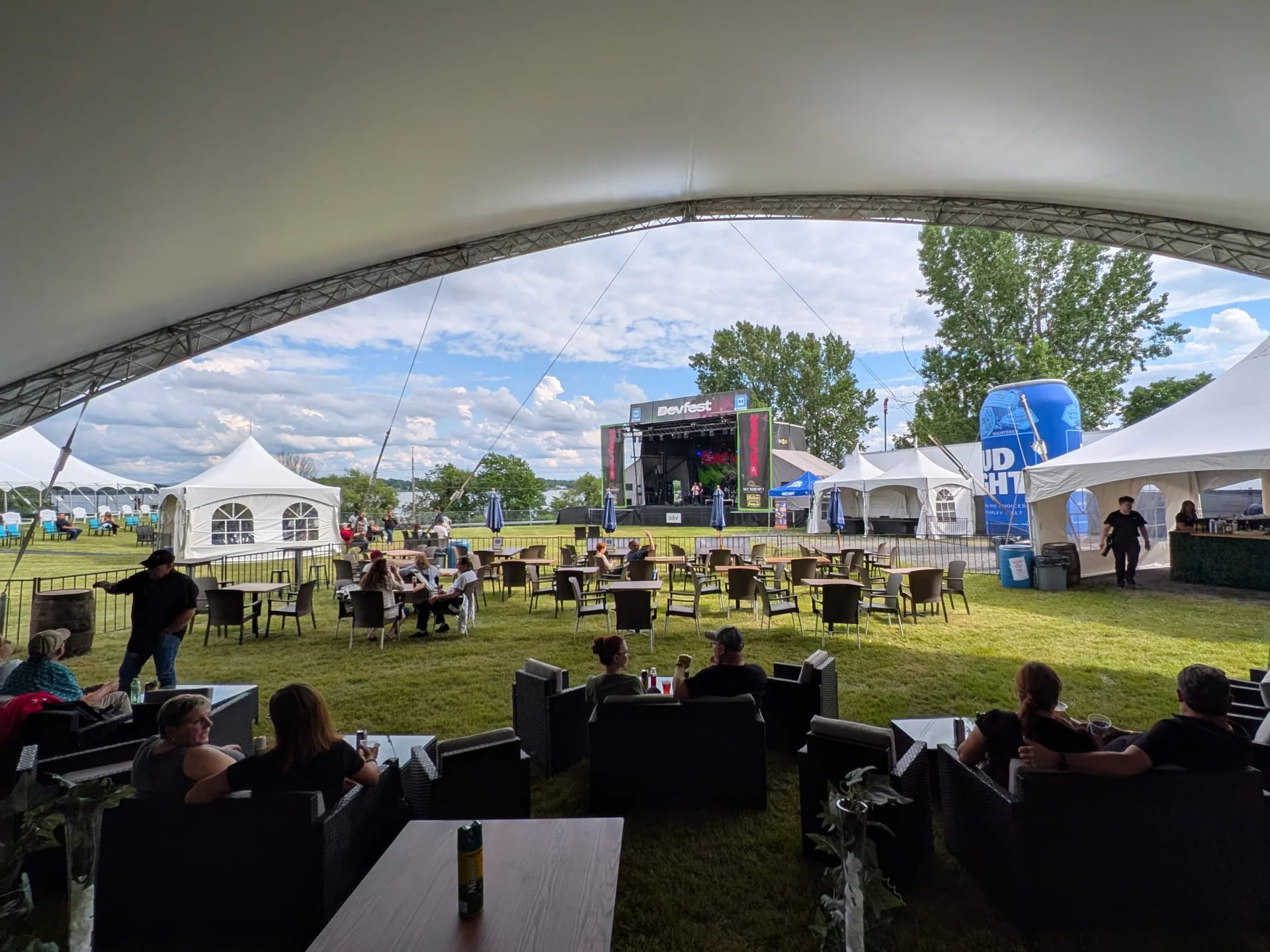 Dôme VIP au DevFest : salons en rotin, tables et scène en arrière-plan